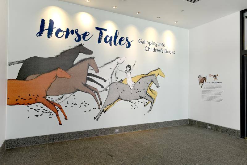 Photograph of installation showing art on walls.