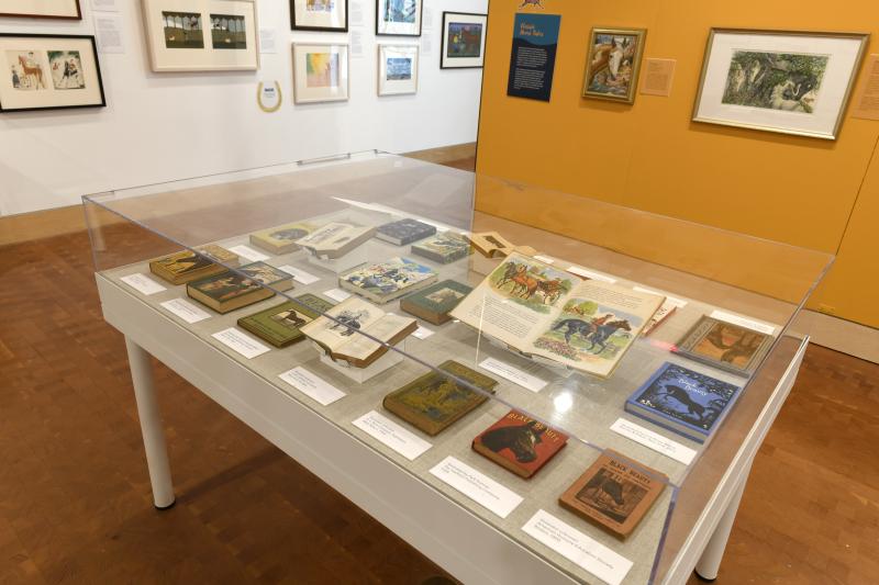 Photograph of installation showing art on walls.
