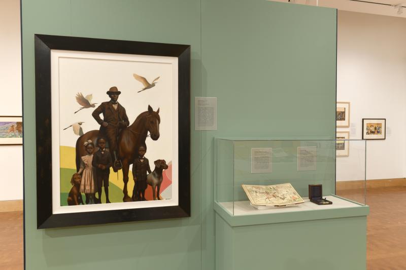 Photograph of installation showing art on walls.