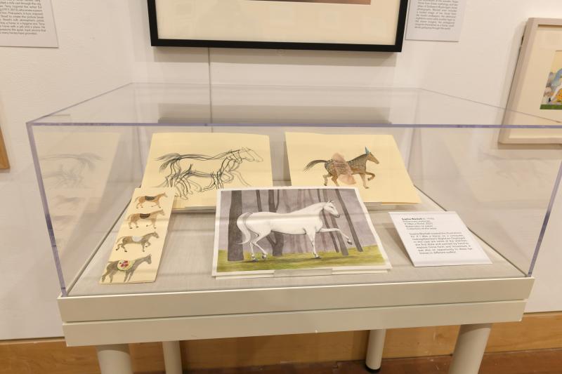 Photograph of installation showing art on walls.