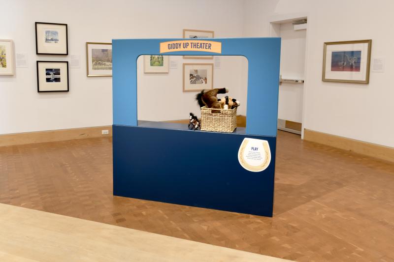 Photograph of installation showing art on walls.