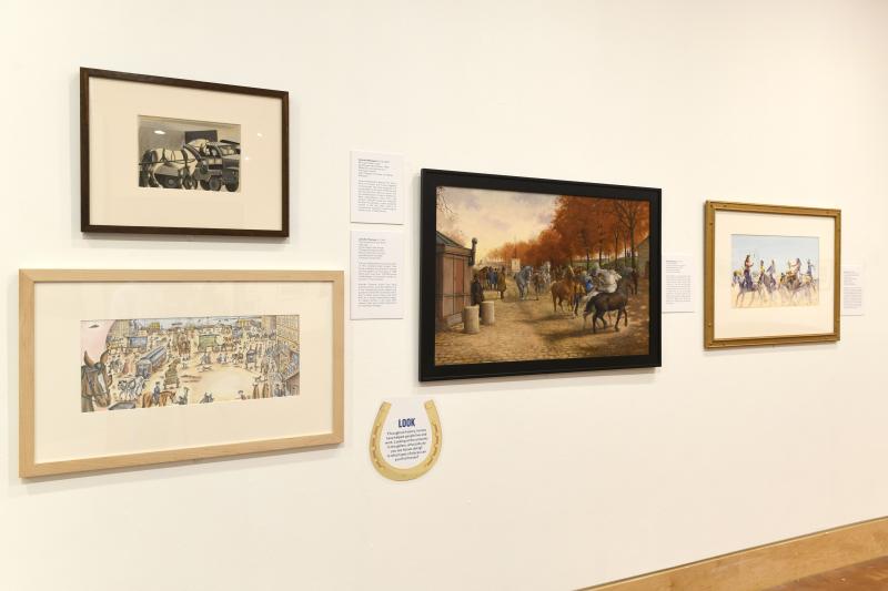 Photograph of installation showing art on walls.
