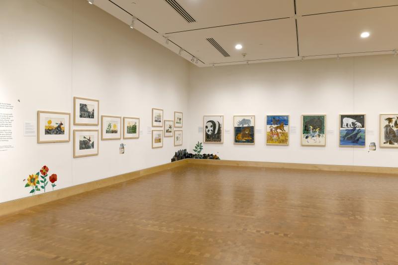 Photograph of gallery showing framed art and graphics.