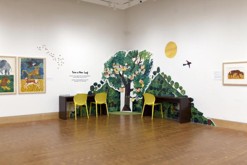 Photograph of gallery showing framed art and graphics.