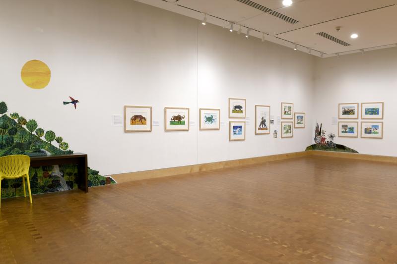 Photograph of gallery showing framed art and graphics.