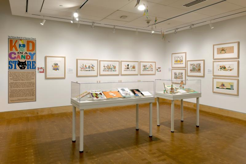 Photograph of gallery showing framed art and graphics.