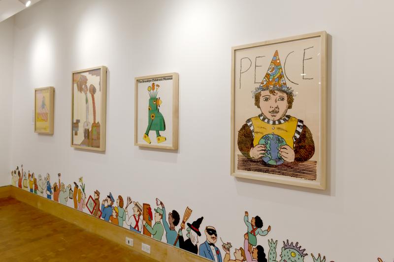 Photograph of gallery showing framed art and graphics.