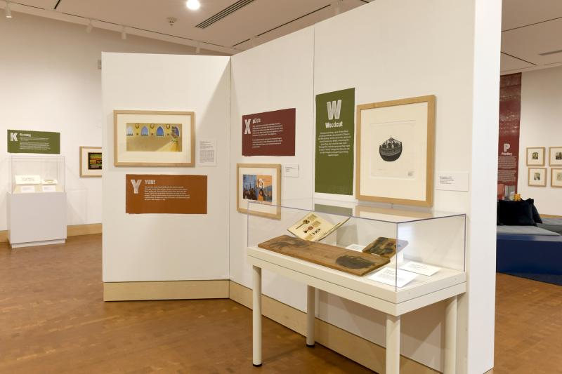 Photograph of gallery showing framed art and graphics.