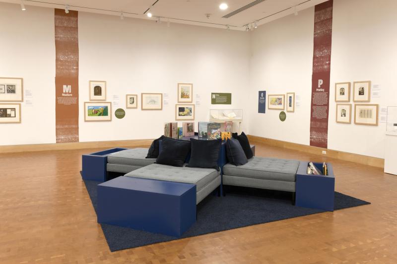 Photograph of gallery showing framed art and graphics.