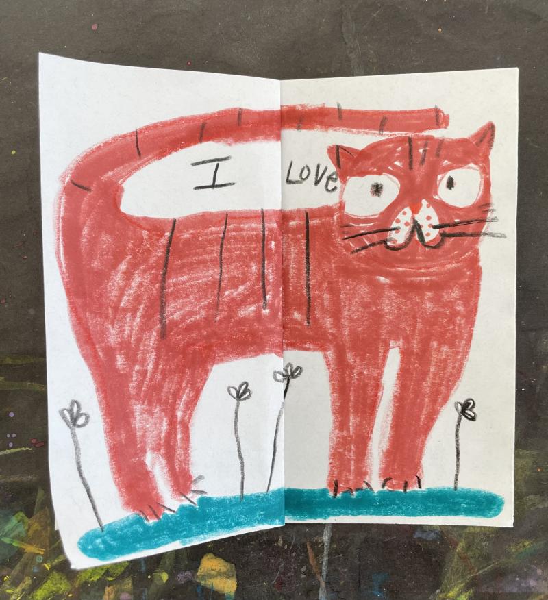 Drawing of an orange cat on a patch of grass with some simple flowers. Image says &quot;I Love&quot; on a square sheet of paper