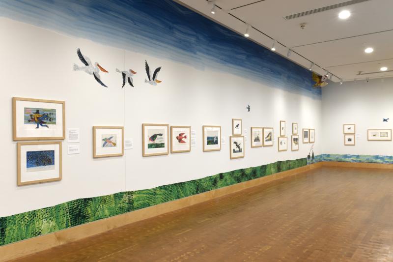 Photograph of gallery showing framed art and graphics.