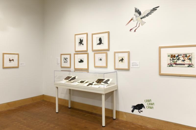 Photograph of gallery showing framed art and graphics.