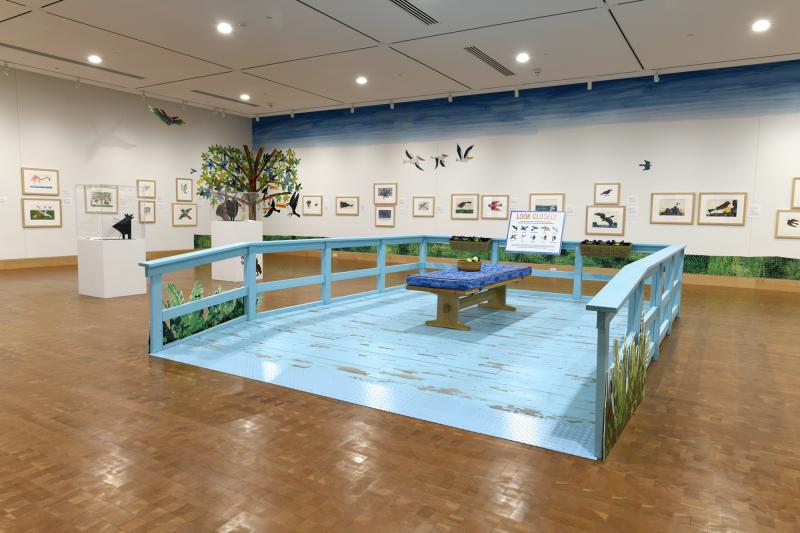 Photograph of gallery showing framed art and graphics.