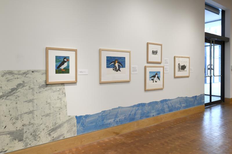Photograph of gallery showing framed art and graphics.