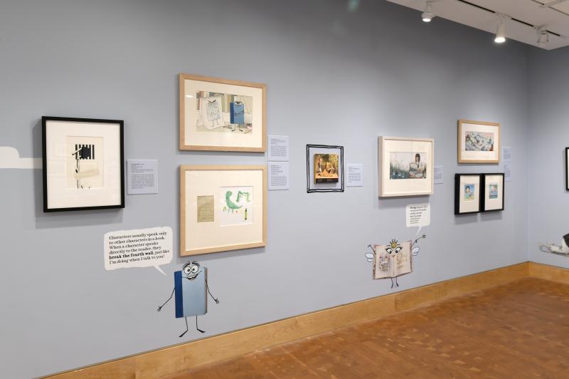 Photograph of gallery showing framed art and graphics.