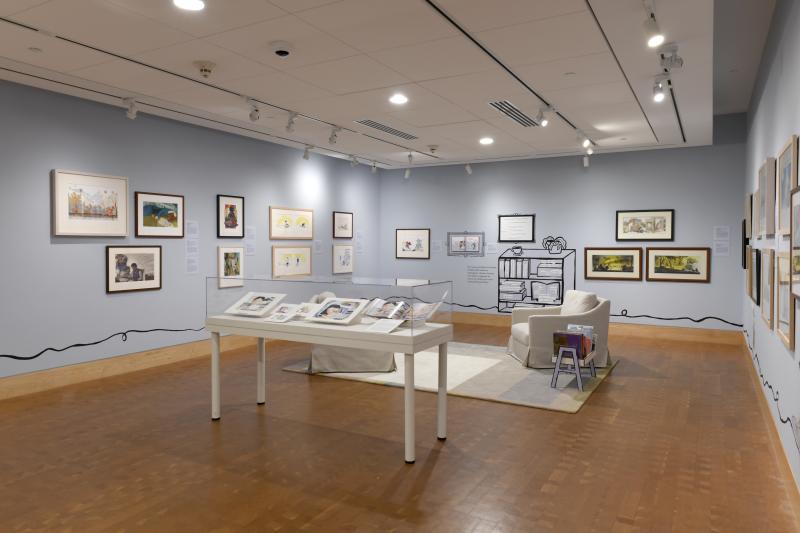 Photograph of gallery showing framed art and graphics.