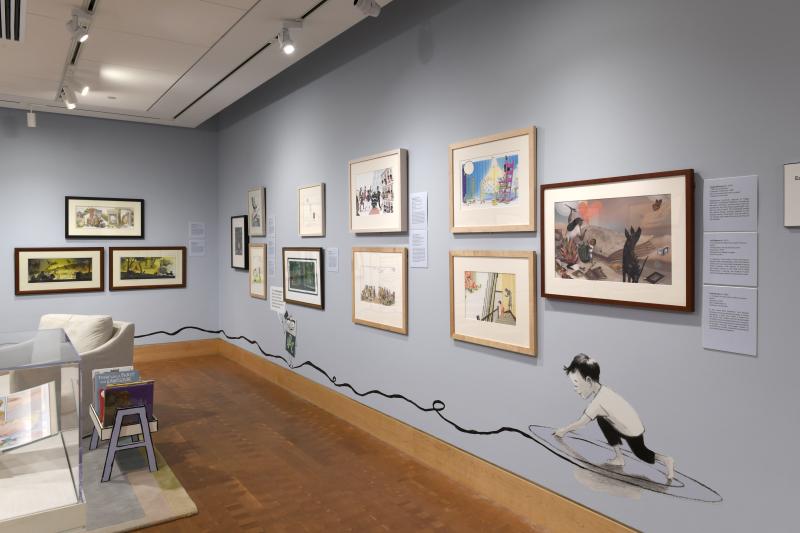 Photograph of gallery showing framed art and graphics.
