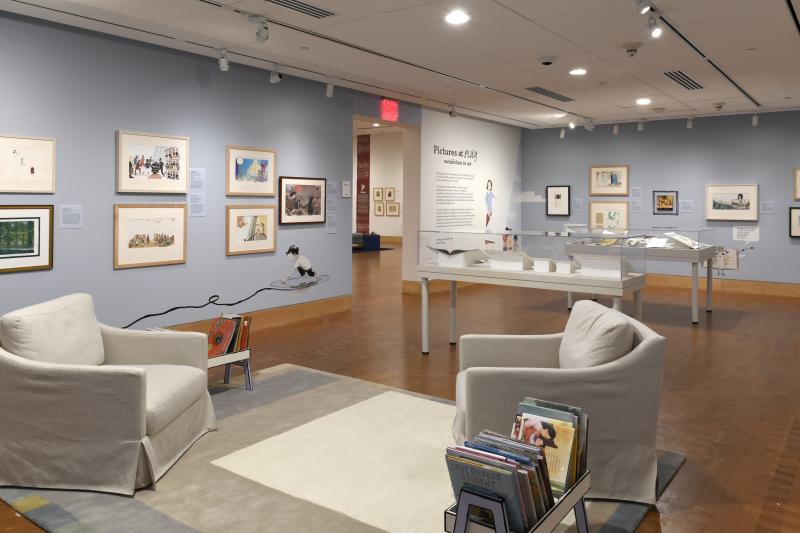 Photograph of gallery showing framed art and graphics.