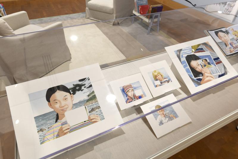 Photograph of gallery showing framed art and graphics.