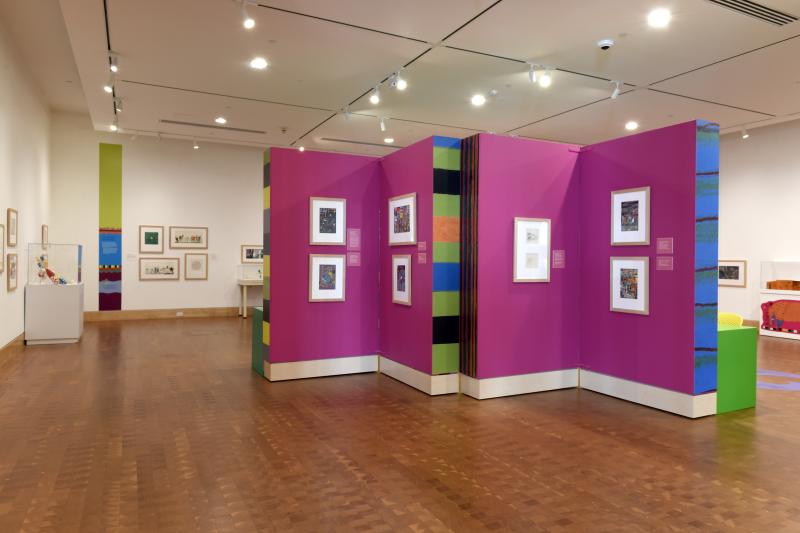Photograph of gallery showing framed art and graphics.