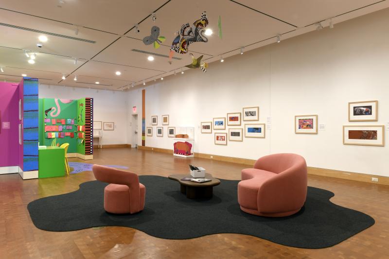 Photograph of gallery showing framed art and graphics.