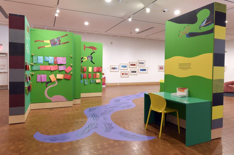 Photograph of gallery showing framed art and graphics.