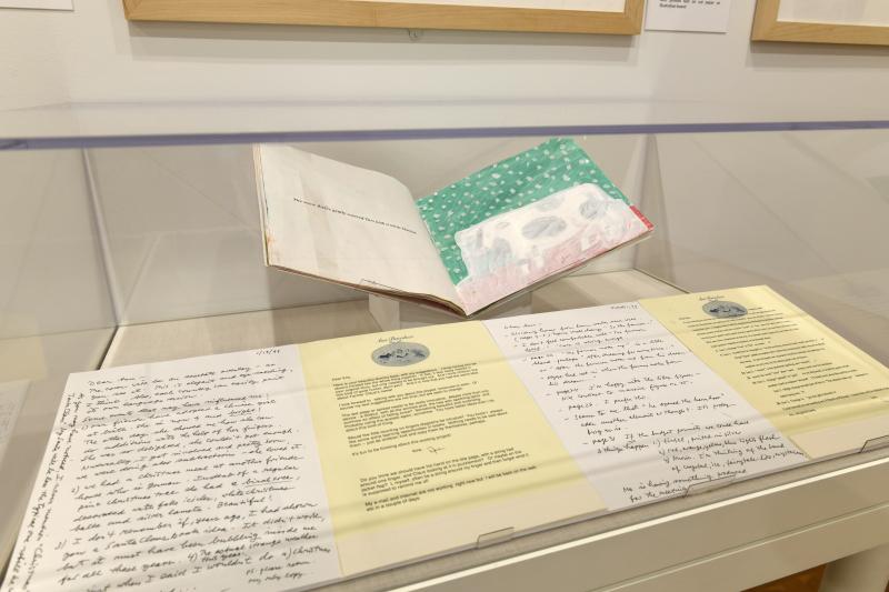 Photograph of gallery showing framed art and graphics.