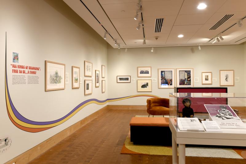 Photograph of gallery showing framed art and graphics.