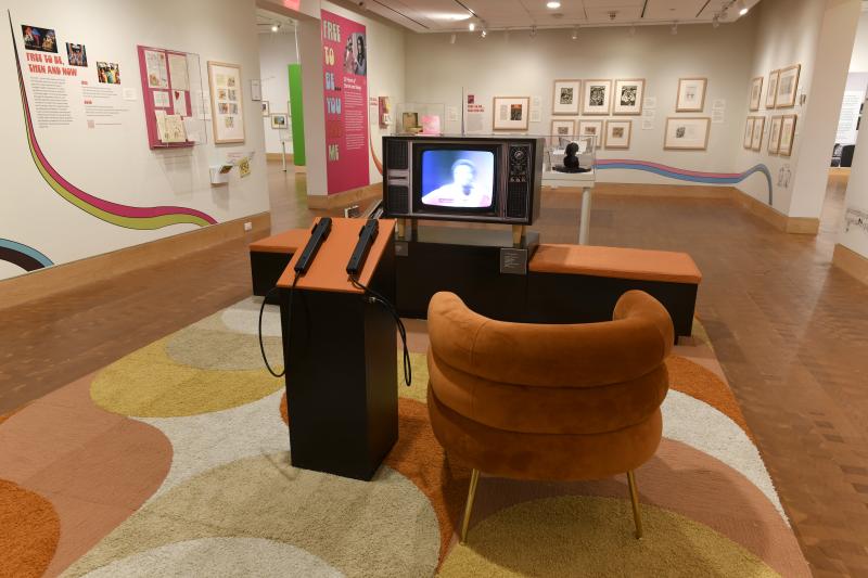 Photograph of gallery showing framed art and graphics.