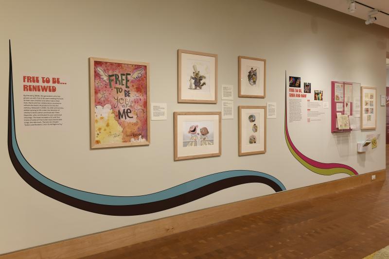 Photograph of gallery showing framed art and graphics.