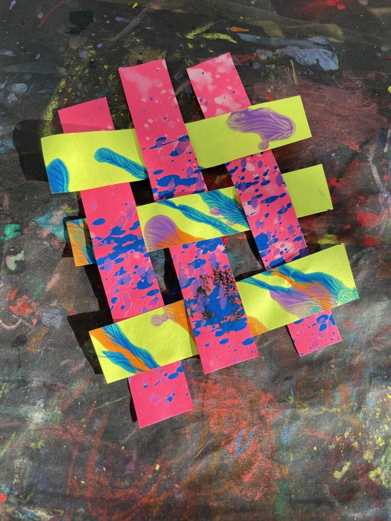 Paper strips woven together.