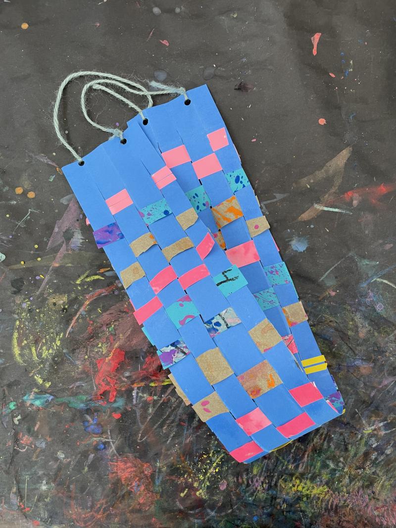 Blue base, colorful paper woven in and out into a band.