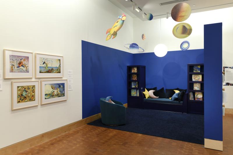 Photograph of gallery showing framed art and graphics.