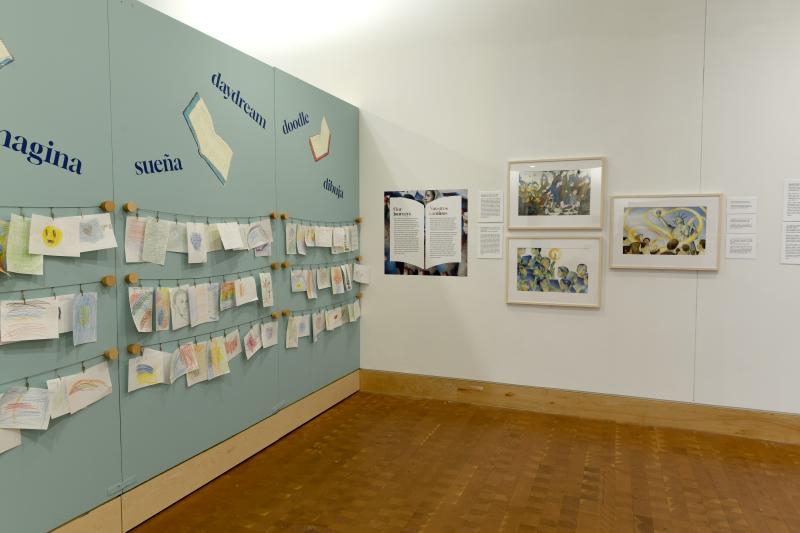 Photograph of gallery showing framed art and graphics.