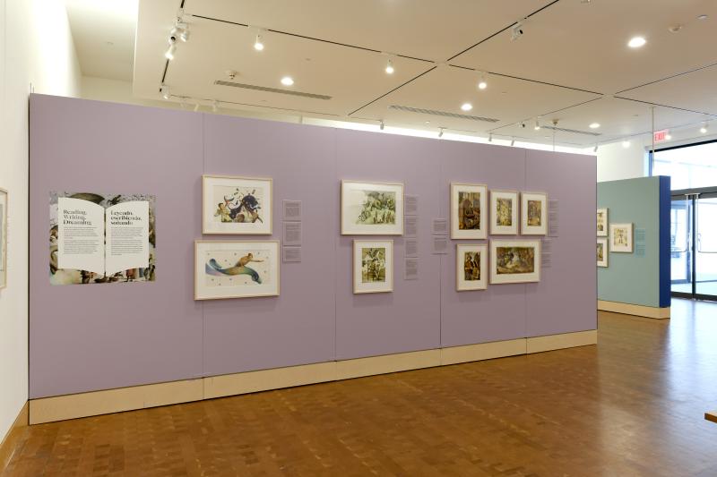 Photograph of gallery showing framed art and graphics.