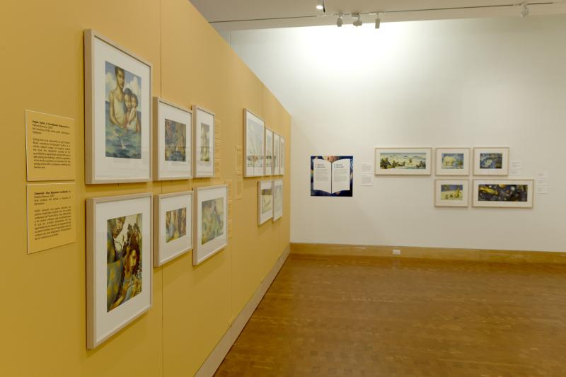 Photograph of gallery showing framed art and graphics.
