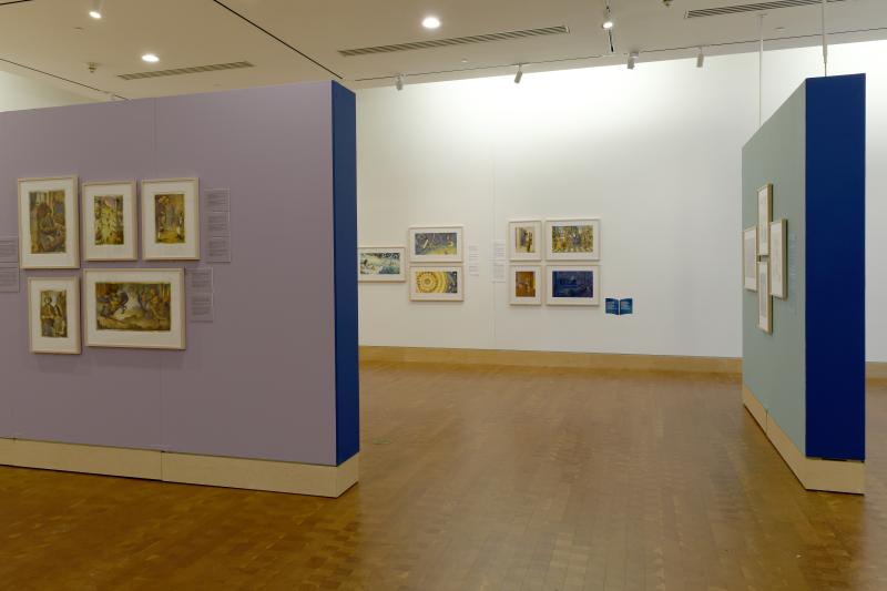 Photograph of gallery showing framed art and graphics.