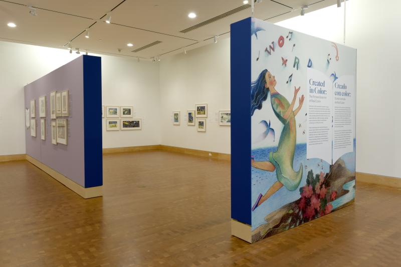 Photograph of gallery showing framed art and graphics.