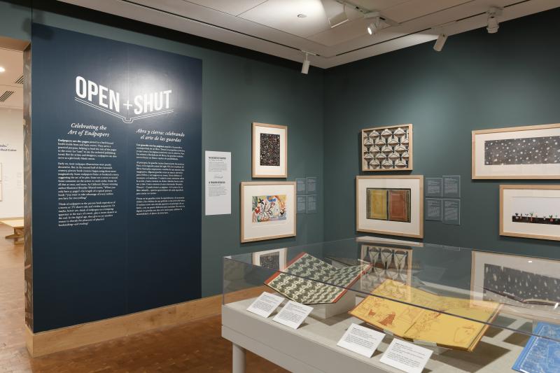 Photograph of gallery showing framed art and graphics.