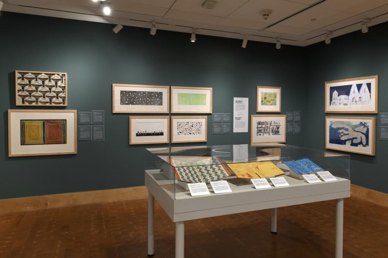 Photograph of gallery showing framed art and graphics.