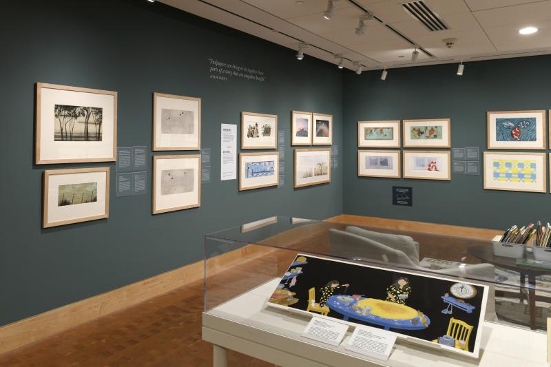 Photograph of gallery showing framed art and graphics.