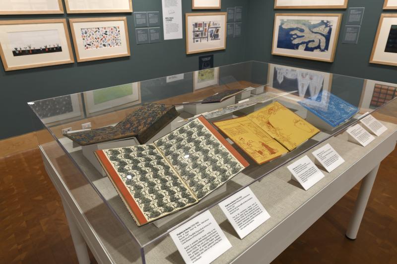 Photograph of gallery showing framed art and graphics.