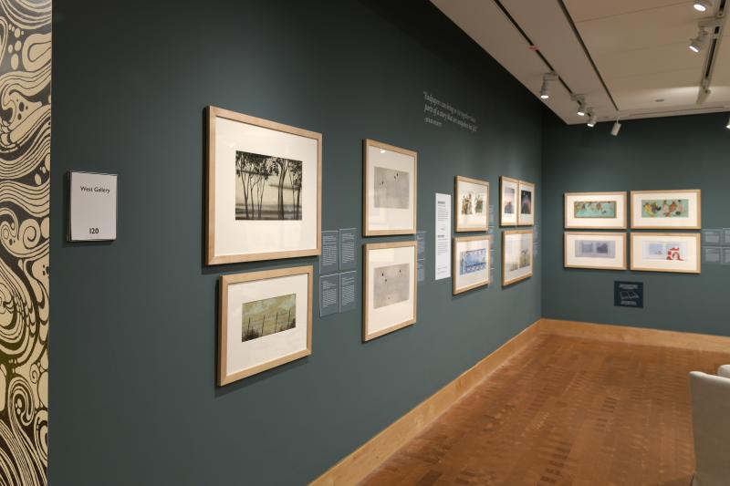 Photograph of gallery showing framed art and graphics.