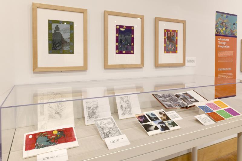 Photograph of gallery showing framed art and graphics.
