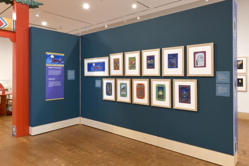 Photograph of gallery showing framed art and graphics.