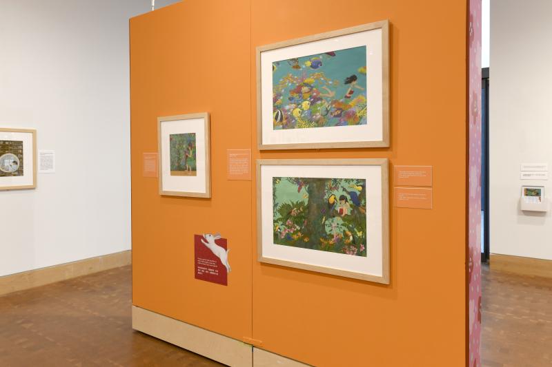 Photograph of gallery showing framed art and graphics.
