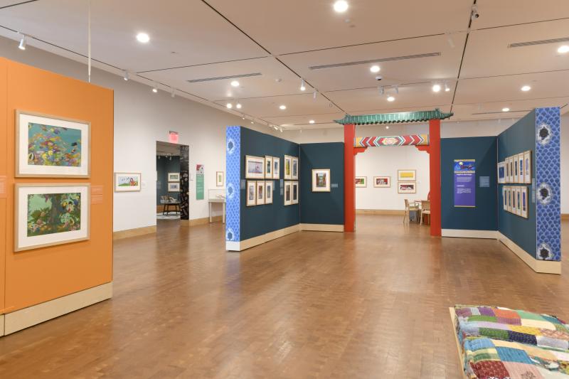 Photograph of gallery showing framed art and graphics.