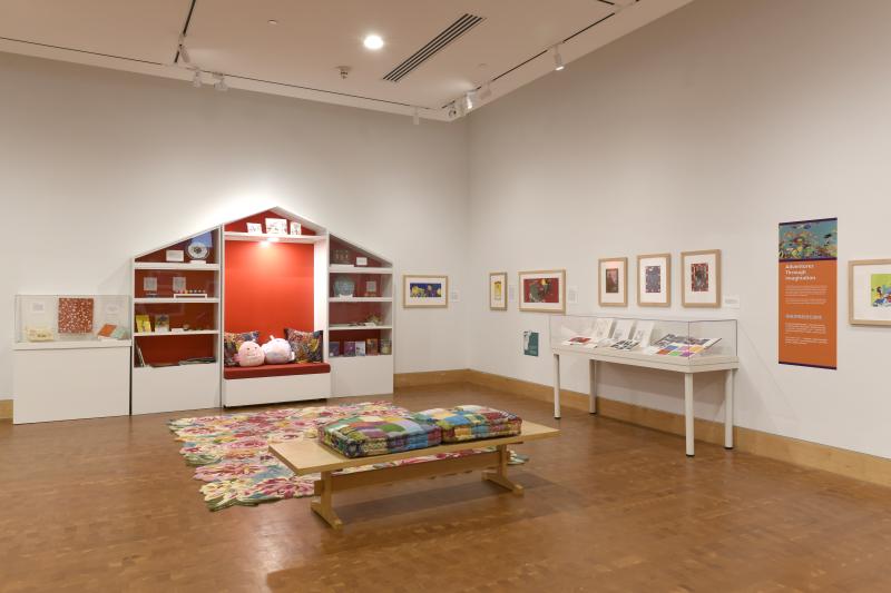 Photograph of gallery showing framed art and graphics.