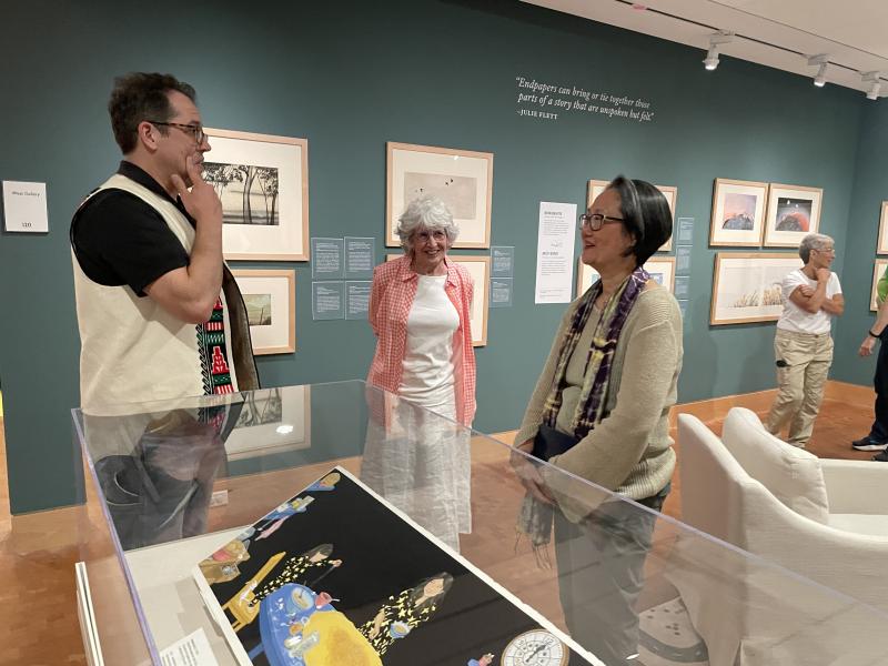 people in the art galleries talk with Dr. Lee Francis