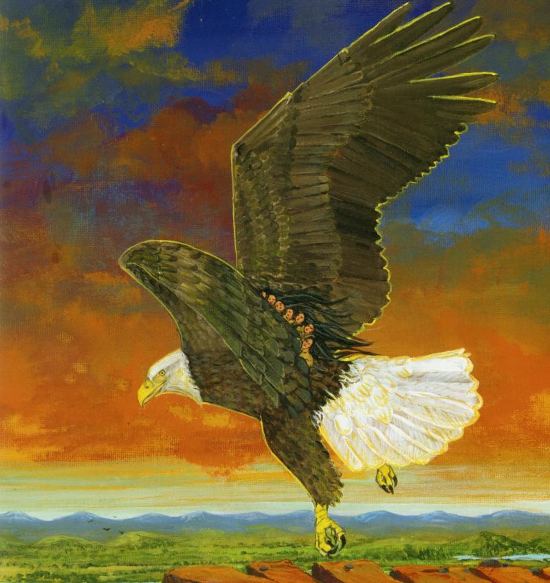 An eagle flies with mountains on the horizon and blue sky with orange clouds